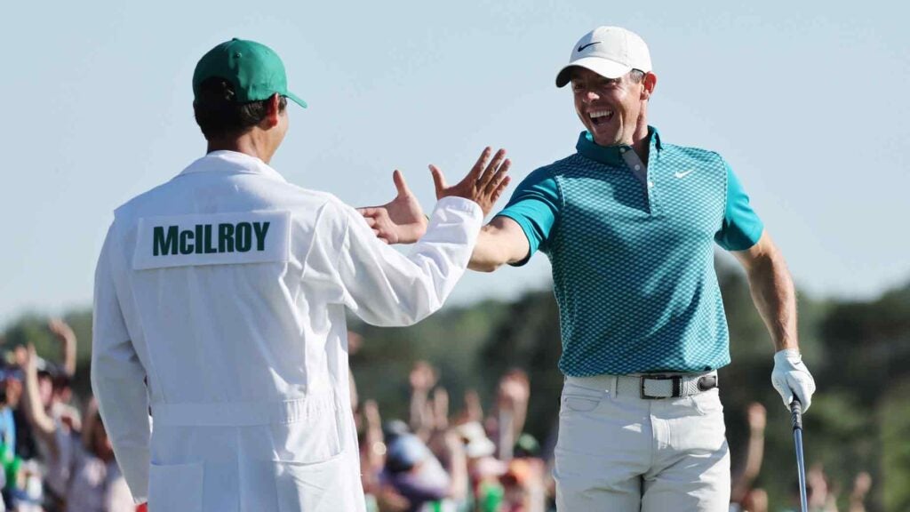 Rory McIlroy high-fives caddie