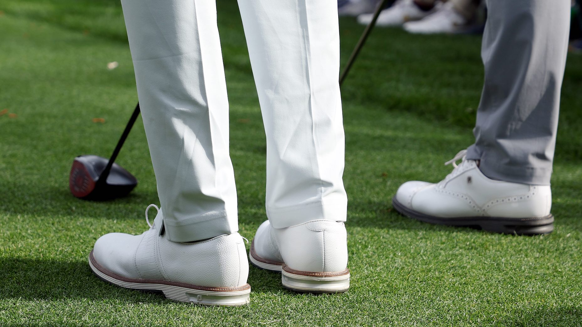 The outer soles of a pair of golf shoes showing movement specific