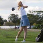 Golf instructor Trillium Rose hits shot