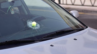 golf ball in broken windshield