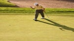 A golfer pumps their fist on the green.