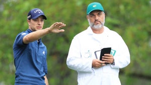 Guido Migliozzi of Italy and caddie Alberto Villanueva lines up a shot on the fourth tee during the first round of the Masters at Augusta National Golf Club on April 07, 2022 in Augusta, Georgia.