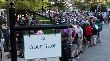 Patrons line up to enter the golf shop at the Masters.