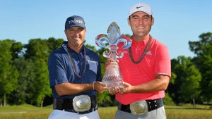ryan palmer holds trophy with another man
