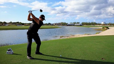 Patrick Reed hits a tee shot during the 2021 Hero World Challenge.