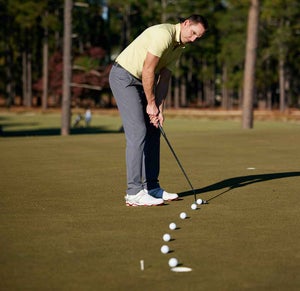 A man putts with his head up.