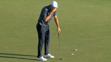 Scottie Scheffler covers his mouth after missing a bogey putt on the 18th green on Sunday.