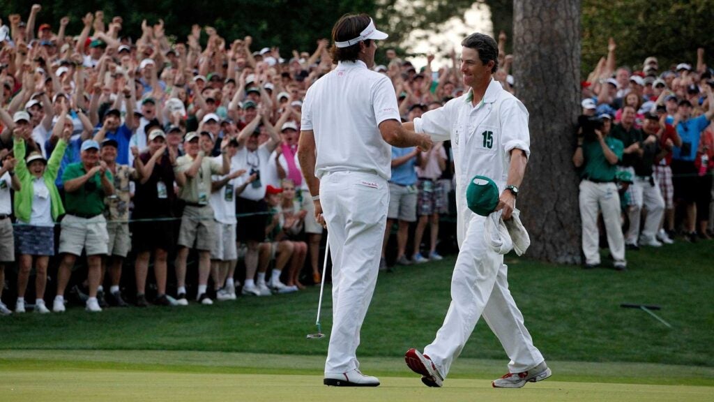 Bubba Watson (L) of the United States hugs his caddie Ted Scott after winning his sudden death playoff on the second playoff hole to win the 2012 Masters Tournament by one stroke at Augusta National Golf Club on April 8, 2012 in Augusta, Georgia.