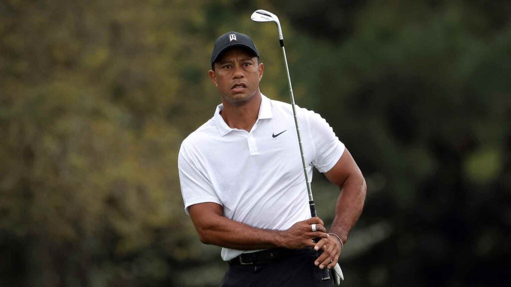 Tiger Woods chips onto a green on Wednesday at the Masters.
