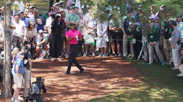 Tiger Woods hits a shot out of the pine straw on Thursday at the Masters.