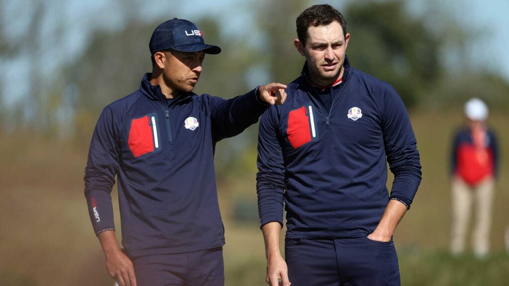 Xander Schauffele and Patrick Cantlay line up a putt at 2021 Ryder Cup