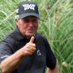 Pro golfer Gary Player gives thumbs up to camera