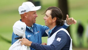 Stewart Cink of the United States and his caddie and son Reagan Cink hug ont he 18th hole during the third round of the 2022 PGA Championship at Southern Hills Country Club on May 21, 2022 in Tulsa, Oklahoma