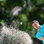 Golfer playing out of a bunker