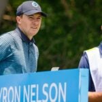 Jordan Spieth and caddie Michael Greller stand on tee box at 2021 AT&T Byron Nelson