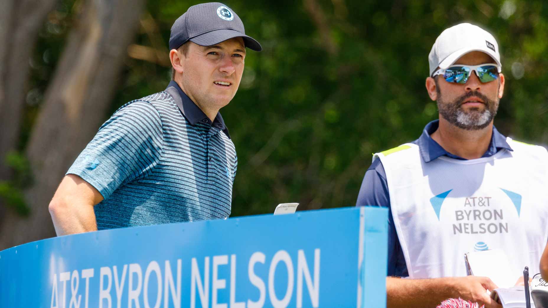Jordan Spieth and caddie Michael Greller stand on tee box at 2021 AT&T Byron Nelson