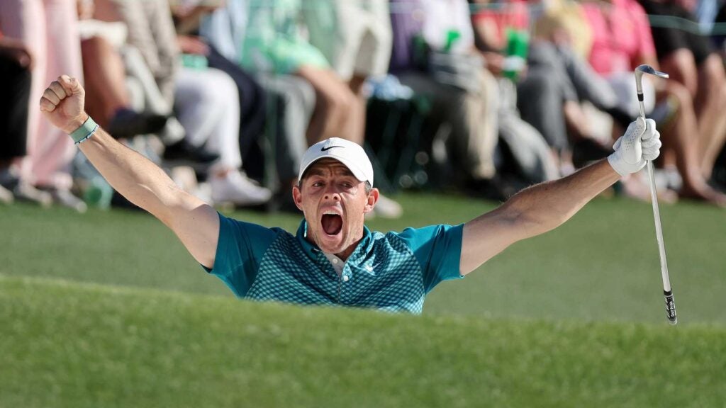 Rory McIlroy raises arms after chipping in at 2022 Masters