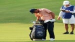 Scottie Scheffler looks in his golf bag at the PGA.