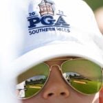Fan with PGA Championship hat watches PGA at Southern Hills