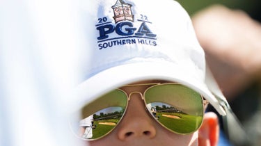 Fan with PGA Championship hat watches PGA at Southern Hills