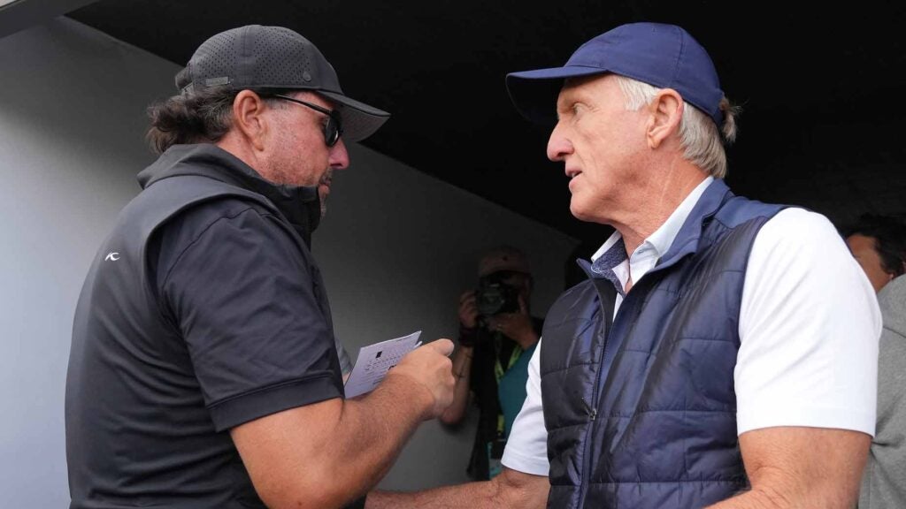 Phil Mickelson and Greg Norman at the conclusion of his Thursday round.