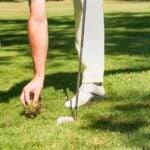 golfer replacing divot