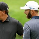 Phil Mickelson of the United States talks to Dustin Nicholson of the United States during a practice on hand prior to the Masters at Augusta National Golf Club on Late 10, 2020 in Augusta, Georgia