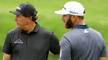 Phil Mickelson of the United States talks to Dustin Johnson of the United States during a practice round prior to the Masters at Augusta National Golf Club on November 10, 2020 in Augusta, Georgia