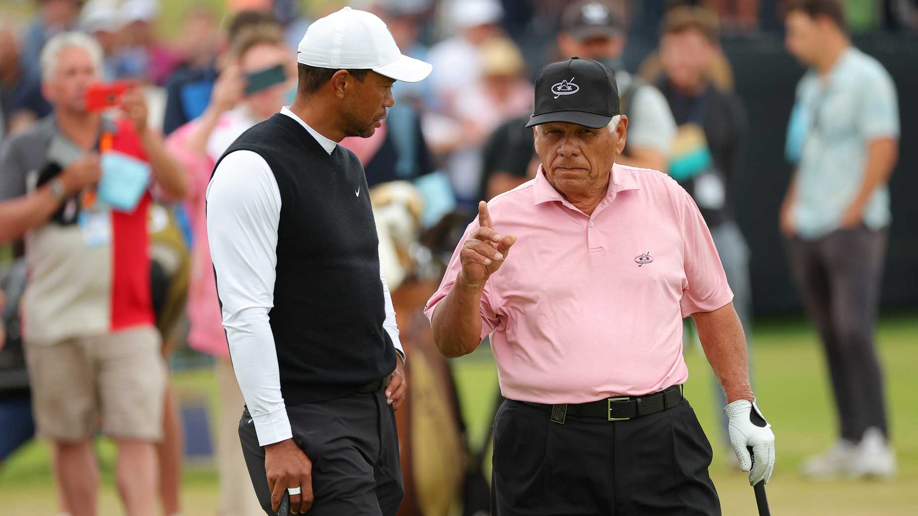 Tiger Woods and Lee Trevino talking shop at St.  Andrews.