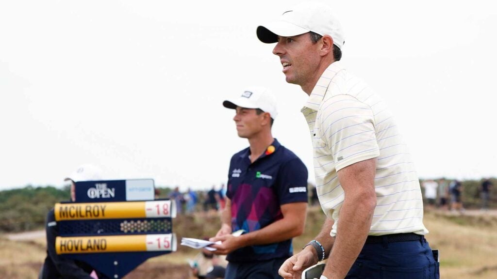 rory mcilroy stands in front of scorecard