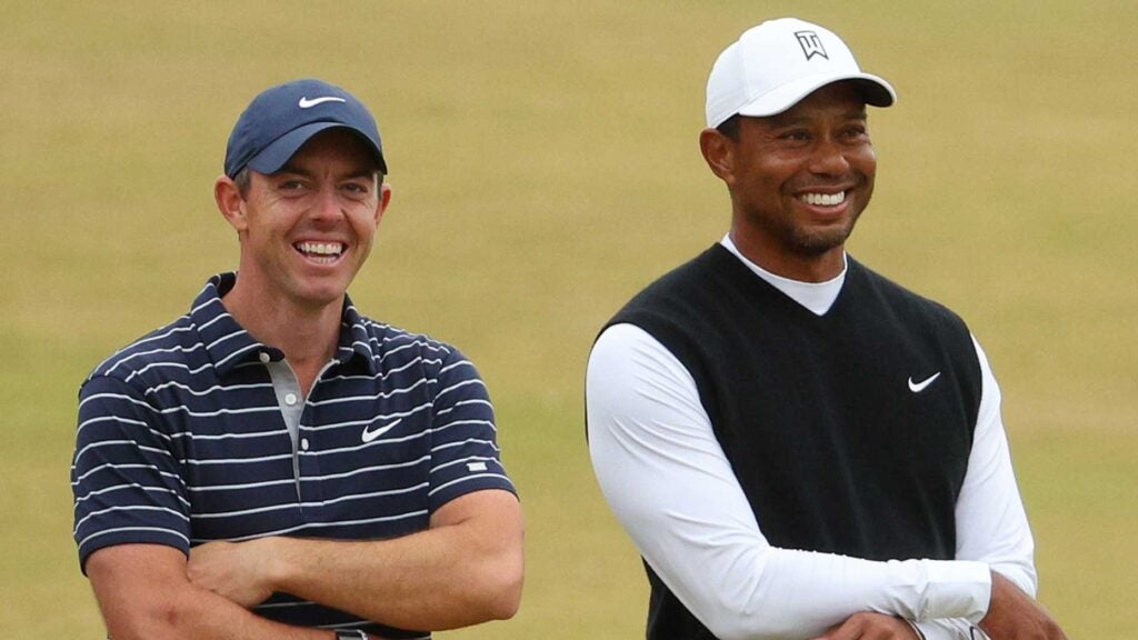 Tiger Woods and Rory McIlroy share a laugh at the Old Course on Monday.