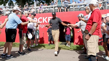 Tony Finau high fives fans during Rocket Mortgage Classic 2022