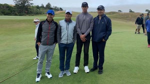 Fans David Zhou. Xian Zhang and Wen Wu Wang pose with Wenyi Ding (second from right) during Saturday's finale at Bandon Dunes.