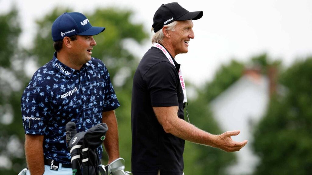 Patrick Reed and Greg Norman talk at Bedminster.