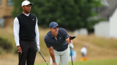 Rory McIlroy, Tiger Woods watch a tee shot at the Open.