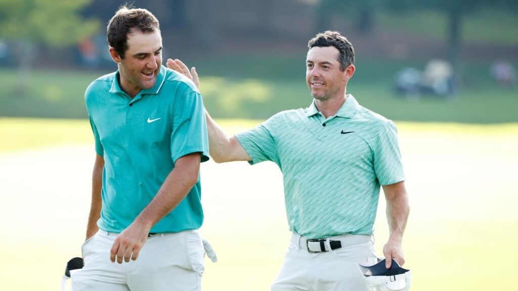Scottie Scheffler of the United States congratulates Rory McIlroy of Northern Ireland on the 18th green after McIlroy won during the final round of the TOUR Championship at East Lake Golf Club on August 28, 2022 in Atlanta, Georgia.