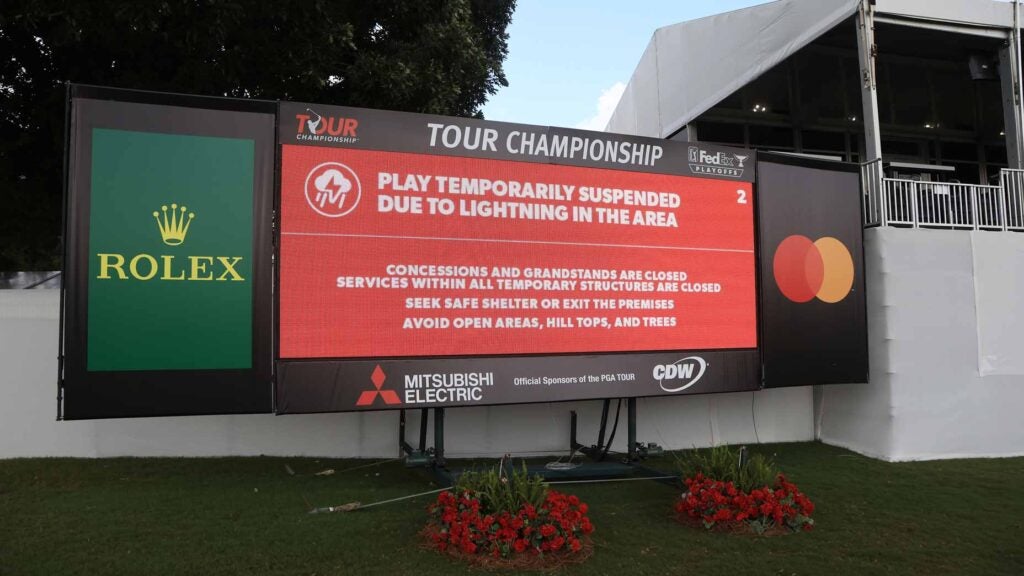 A leaderboard indicates that play is suspended due to inclement weather during the third round of the TOUR Championship at East Lake Golf Club on August 27, 2022 in Atlanta, Georgia.