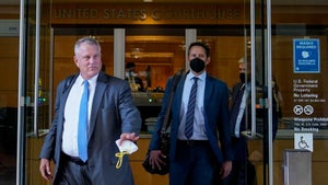 Elliot Peters, left, an attorney representing the PGA Tour, leaves a U.S. courthouse in San Jose, Calif., Tuesday,