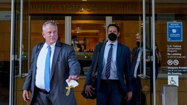 Elliot Peters, left, an attorney representing the PGA Tour, leaves a U.S. courthouse in San Jose, Calif., on Tuesday,