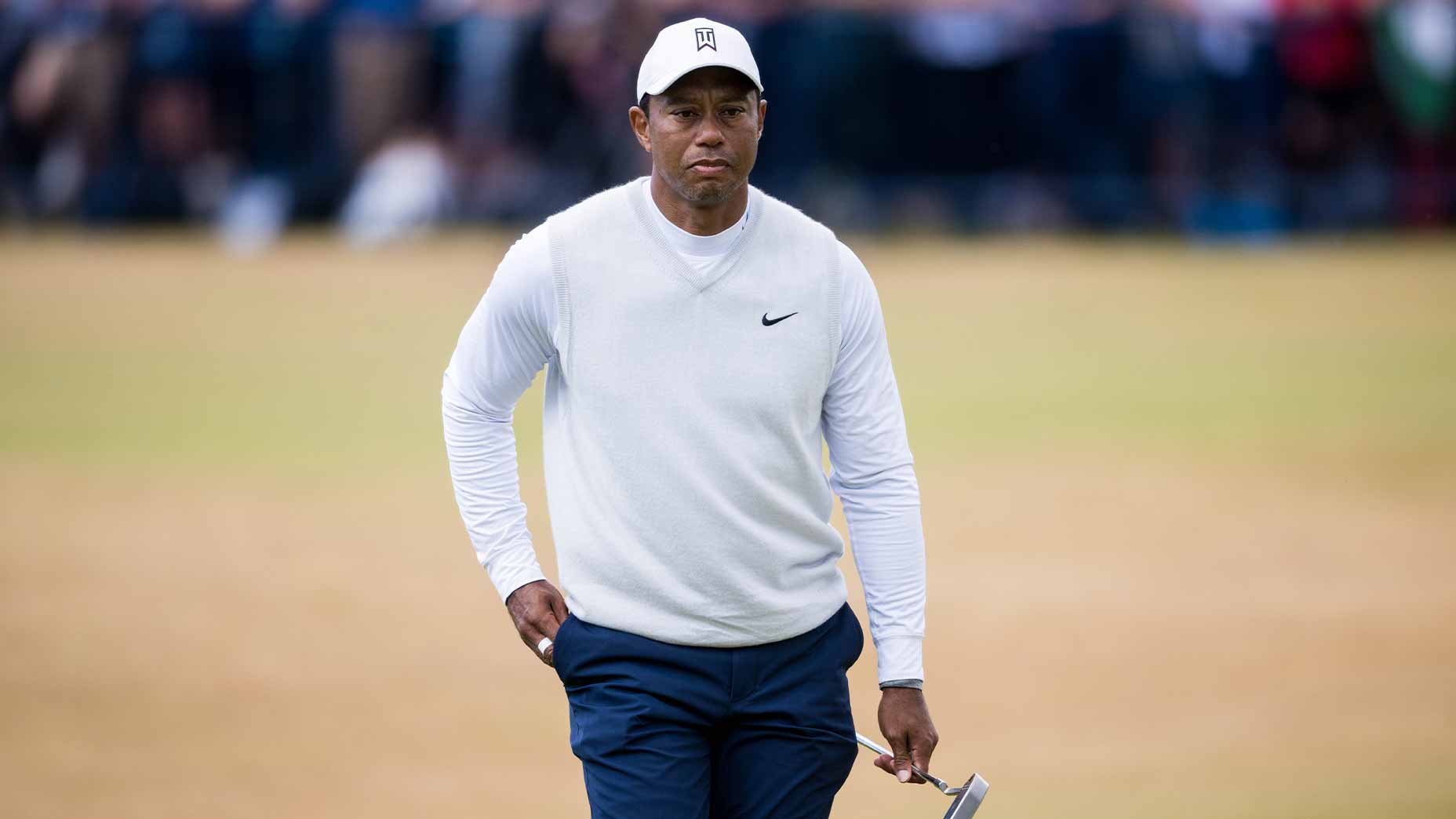 tiger woods holds putter open