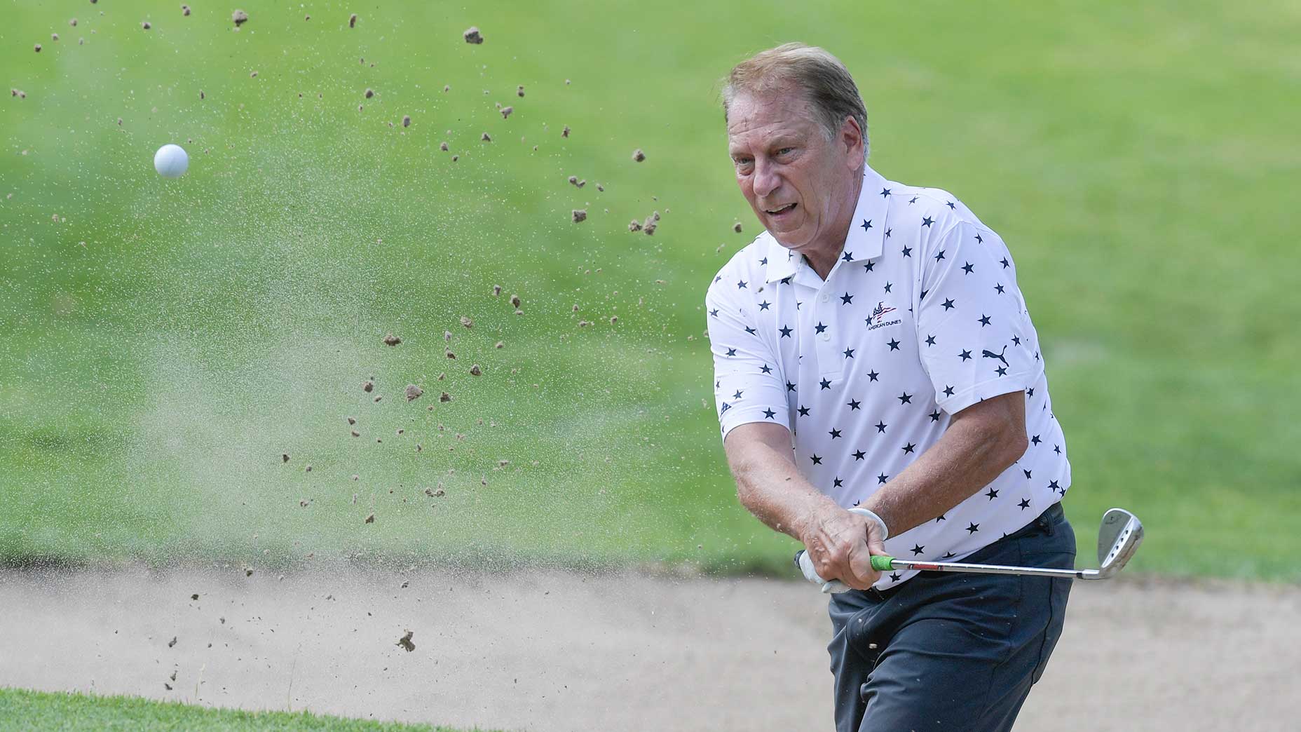 tom Izzo blasts out of a bunker