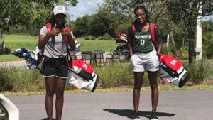 two women with golf bags