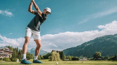 Casper Ruud hits a golf shot in Austria.