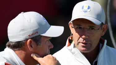 Paul Casey of England and team Europe (L) and captain Padraig Harrington of Ireland and team Europe meet on the 17th green during Saturday Morning Foursome Matches of the 43rd Ryder Cup at Whistling Straits on September 25, 2021 in Kohler, Wisconsin.