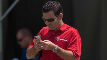 NFL Network reporter Ian Rapoport checks his phone during the Indianapolis Colts Training Camp practice at Anderson University in Anderson, IN.