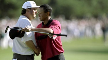 Tiger Woods hugs Billy Ray Brown after Tiger wins the Buick Invitational at the Torrey Pines Golf Course in La Jolla, California.