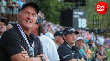 Greg Norman and Patrick Reed staring at a game of golf