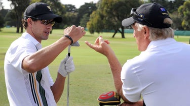 Australian Adam Scott (L) talks with team captain Greg Norman (R) during a practice round as the International team prepares to take on the US at the President's Cup tournament at the Royal Melbourne golf course, in Melbourne on November 16, 2011.