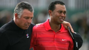 Caddie Steve Williams escorted a teary Tiger Woods off the 18th green at Royal Liverpool.