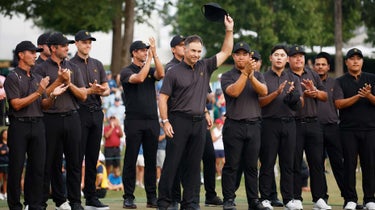 Captain Trevor Immelman of the International Team reacts alongside the International Team during the closing ceremony after the Sunday singles matches on day four of the 2022 Presidents Cup at Quail Hollow Country Club on September 25, 2022 in Charlotte, North Carolina.